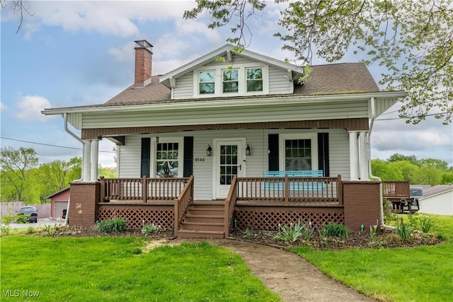4144 Stump Ave SW, Navarre, OH 44662 - view of front facade featuring a porch, a chimney, a front lawn, and a shingled roof