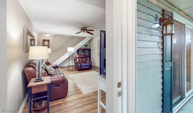 interior space featuring wood finished floors, a ceiling fan, and baseboards