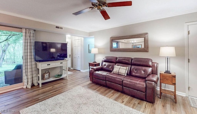 living room featuring ceiling fan, ornamental molding, wood finished floors, and baseboards