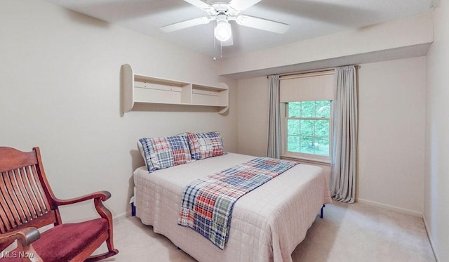 bedroom with light colored carpet, baseboards, and a ceiling fan