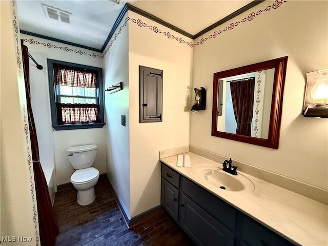 6859 Fairground Blvd, Canfield, OH 44406 - bathroom with vanity, toilet, baseboards, brick patterned flooring, and crown molding