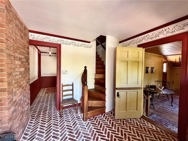 6859 Fairground Blvd, Canfield, OH 44406 - hallway with brick flooring, stairway, wallpapered walls, and ornamental molding