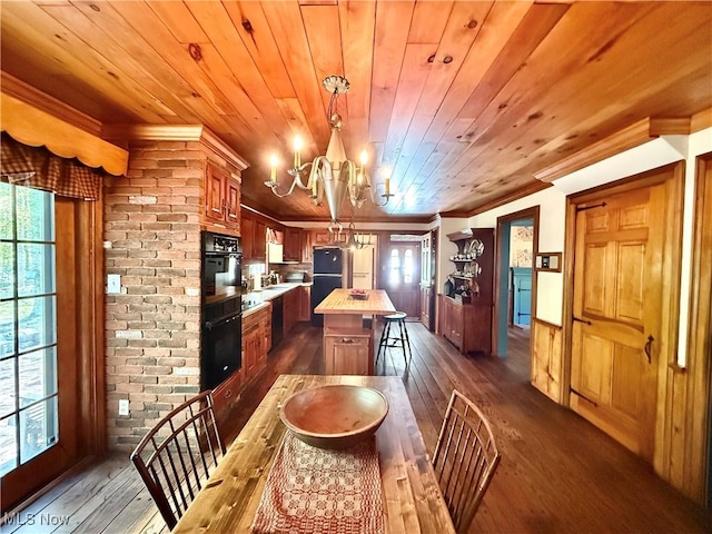 6859 Fairground Blvd, Canfield, OH 44406 - kitchen with a chandelier, crown molding, dark wood finished floors, a center island, and black appliances