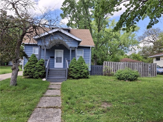 bungalow-style house with roof with shingles