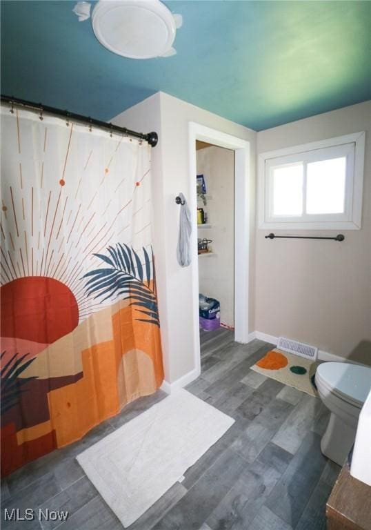 36751 Sugar Ridge Rd, North Ridgeville, OH 44039 - full bathroom with toilet, baseboards, a shower with curtain, and wood finished floors