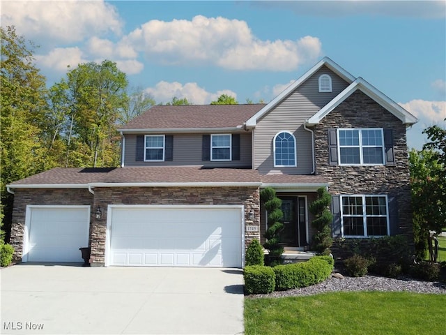 1745 Campbell Ln, Streetsboro, OH 44241 - view of front of property featuring concrete driveway, stone siding, a shingled roof, and a garage