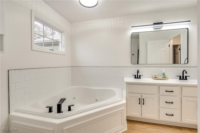 2875 Sherwood Ave NW, Massillon, OH 44646 - full bath with a whirlpool tub, double vanity, and wood finished floors