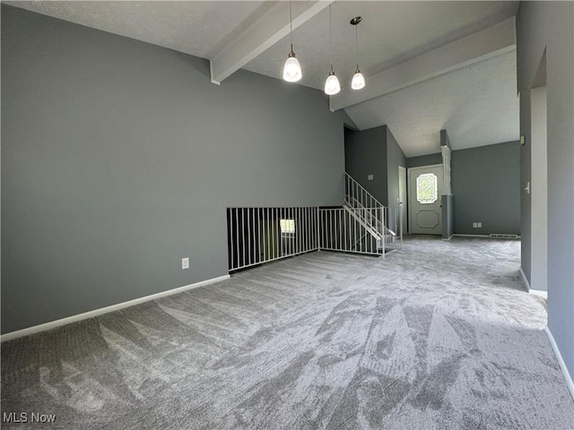 unfurnished living room featuring carpet floors and baseboards