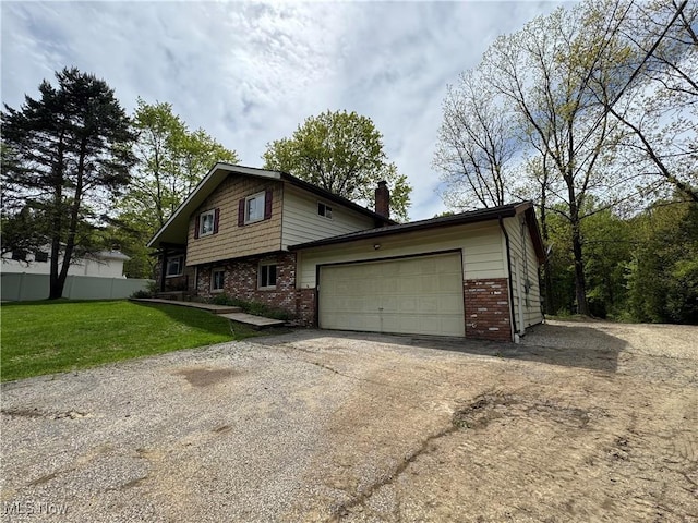 view of front of house with brick siding, driveway, a chimney, and a garage