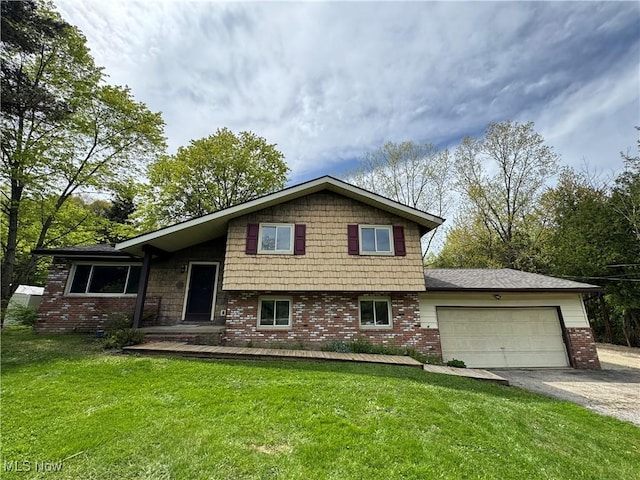 split level home featuring brick siding, asphalt driveway, a garage, and a front lawn
