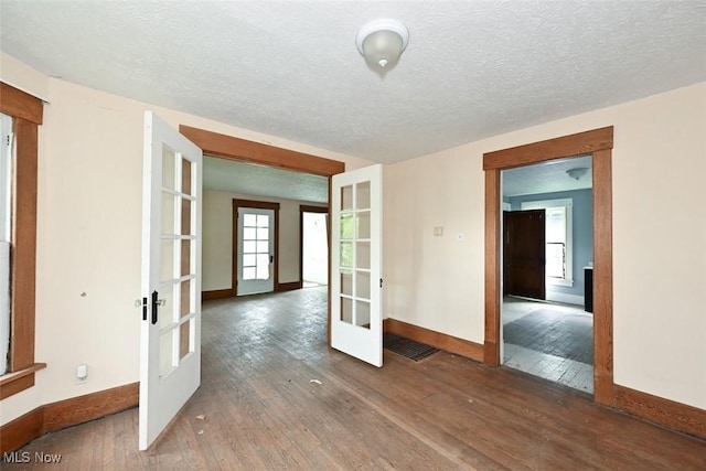 1324-1326 Shorb Ave NW, Canton, OH 44703 - unfurnished room featuring french doors, baseboards, hardwood / wood-style floors, and a textured ceiling