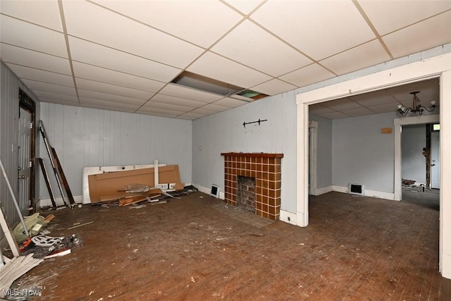 1324-1326 Shorb Ave NW, Canton, OH 44703 - unfurnished living room featuring a paneled ceiling, a fireplace, and baseboards