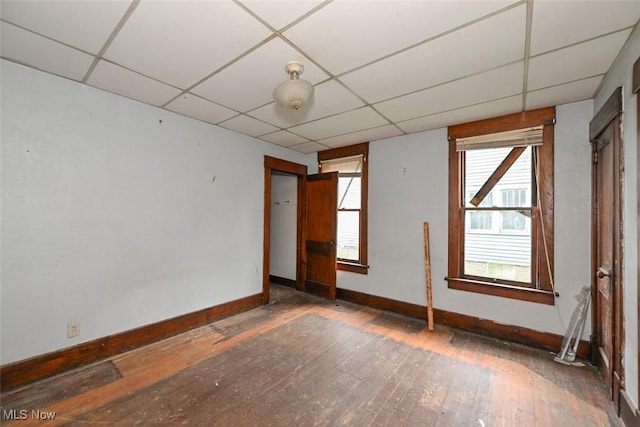 1324-1326 Shorb Ave NW, Canton, OH 44703 - unfurnished room featuring baseboards, a drop ceiling, and hardwood / wood-style flooring