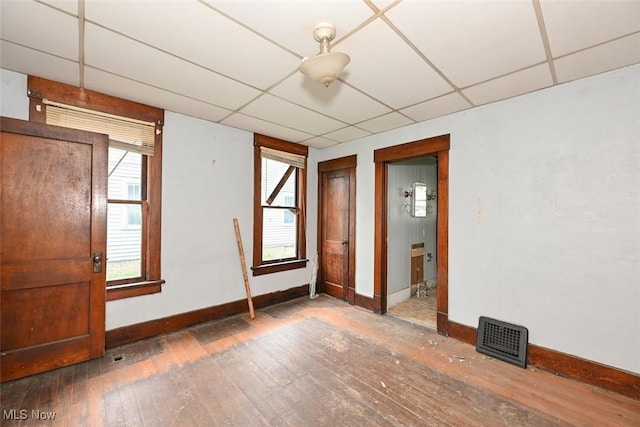 1324-1326 Shorb Ave NW, Canton, OH 44703 - unfurnished room featuring baseboards, a paneled ceiling, and hardwood / wood-style flooring