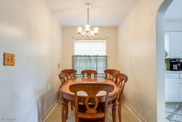 807 Ranney St, Akron, OH 44310 - dining room featuring baseboards, arched walkways, and a chandelier