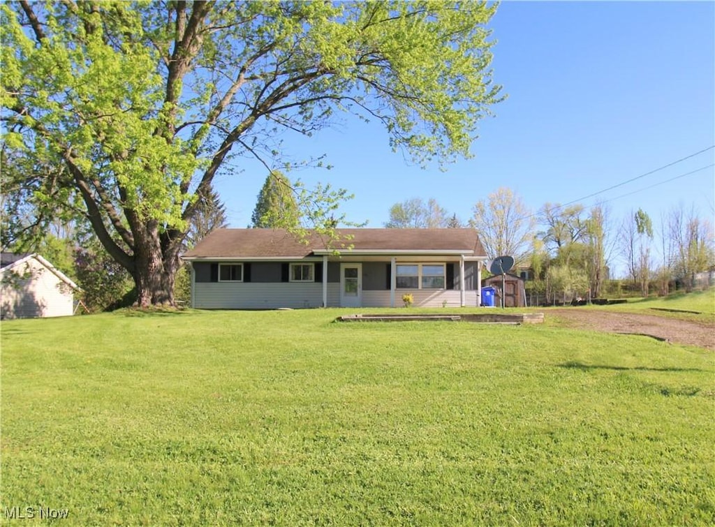 983 State Route 303, Streetsboro, OH 44241 - back of house featuring a storage shed, a yard, and an outdoor structure