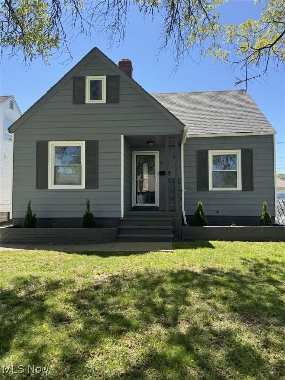 13121 Tyler Ave, Cleveland, OH 44111 - bungalow-style home featuring a chimney and a front yard