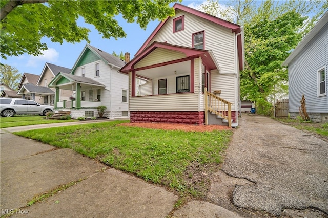 3692 E 118th St, Cleveland, OH 44105 - view of front of house with a front lawn and entry steps