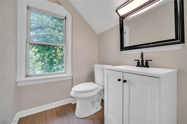 3692 E 118th St, Cleveland, OH 44105 - half bathroom featuring plenty of natural light, vaulted ceiling, baseboards, toilet, and wood finished floors