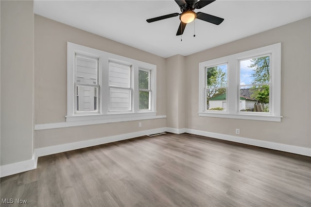 3692 E 118th St, Cleveland, OH 44105 - spare room featuring wood finished floors, baseboards, and ceiling fan