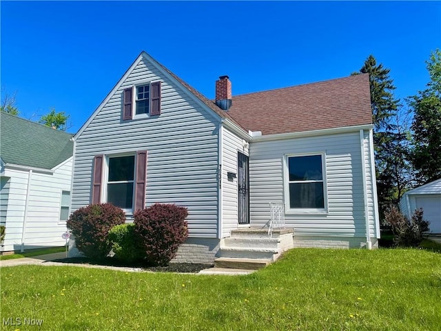 view of front of house featuring a chimney and a front yard