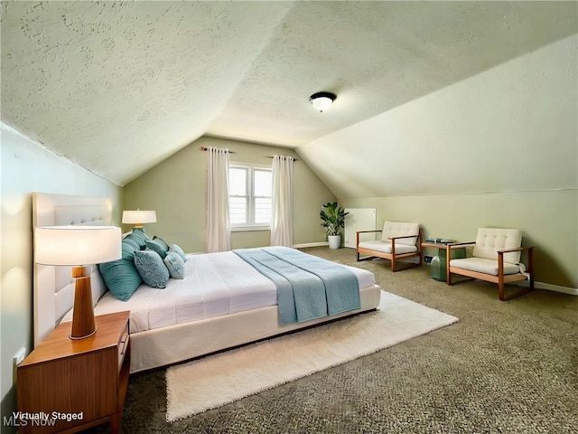 bedroom featuring carpet, vaulted ceiling, a textured ceiling, and baseboards