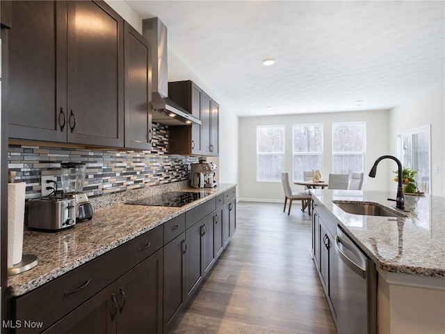 kitchen with a sink, stainless steel dishwasher, black electric stovetop, wall chimney range hood, and dark wood-style floors