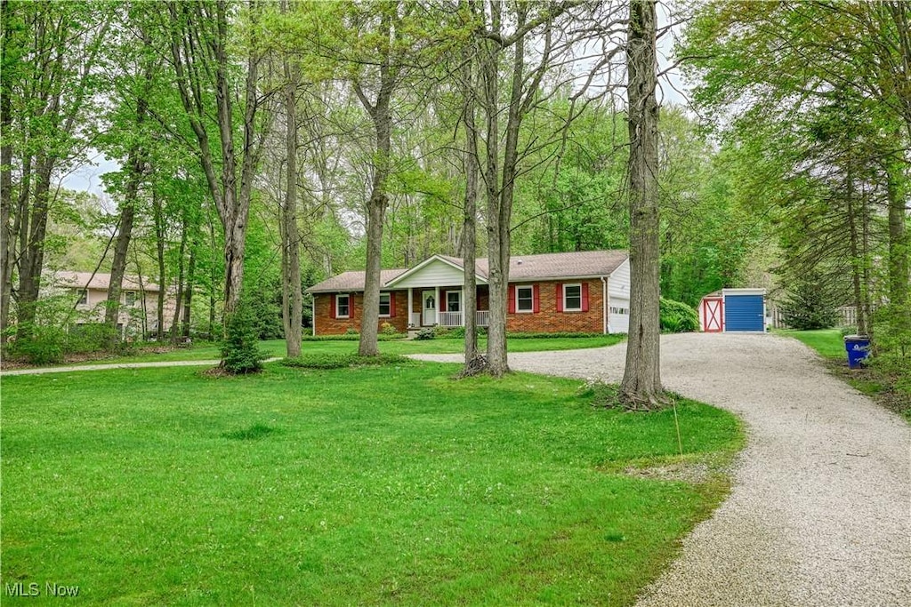 1463 Brimfield Dr, Kent, OH 44240 - ranch-style home with driveway, a front lawn, an outbuilding, a storage unit, and brick siding