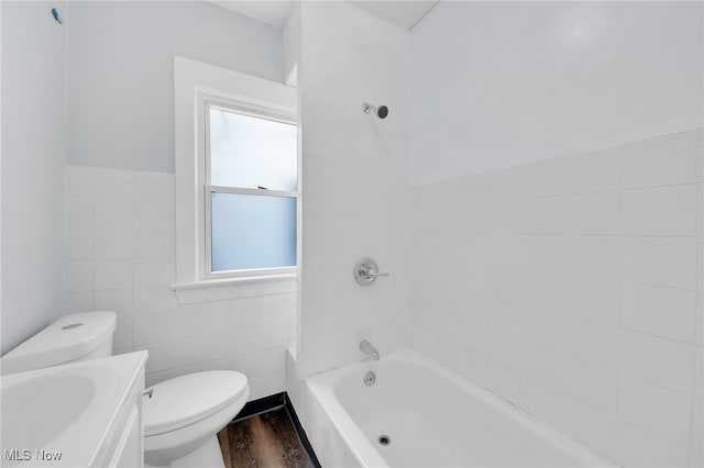 2040 W 103rd St, Cleveland, OH 44102 - full bathroom with toilet, tile walls, healthy amount of natural light, wood finished floors, and shower / bath combination