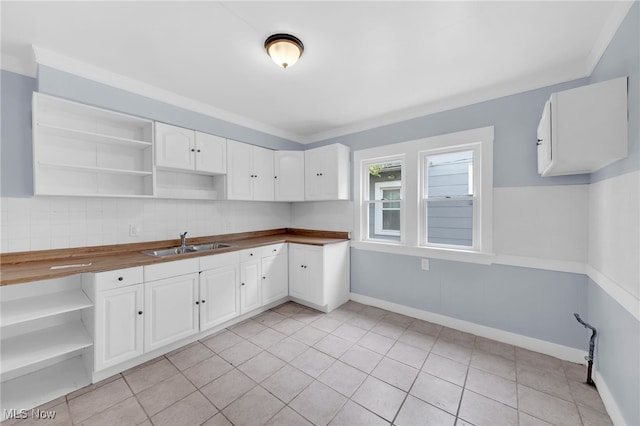 2040 W 103rd St, Cleveland, OH 44102 - kitchen featuring open shelves, a sink, white cabinetry, and decorative backsplash