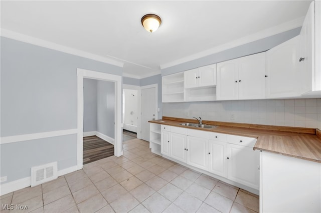2040 W 103rd St, Cleveland, OH 44102 - kitchen with open shelves, a sink, white cabinetry, light tile patterned flooring, and decorative backsplash