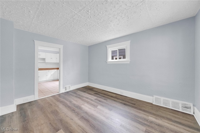 2040 W 103rd St, Cleveland, OH 44102 - empty room with wood finished floors and baseboards