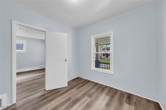 2040 W 103rd St, Cleveland, OH 44102 - spare room with wood finished floors and baseboards