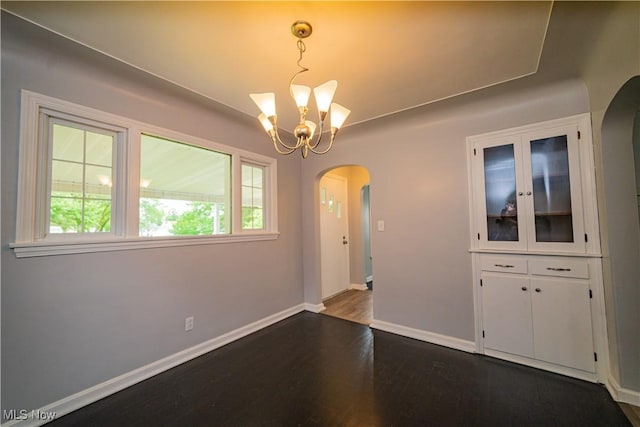 459 N Osborn Ave, Youngstown, OH 44509 - unfurnished dining area featuring arched walkways, dark wood finished floors, a chandelier, and baseboards