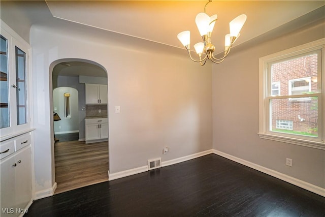459 N Osborn Ave, Youngstown, OH 44509 - empty room featuring dark wood-type flooring, a chandelier, and baseboards