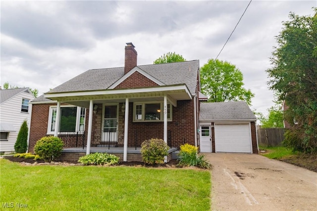 459 N Osborn Ave, Youngstown, OH 44509 - bungalow-style home featuring covered porch, concrete driveway, brick siding, a chimney, and an attached garage
