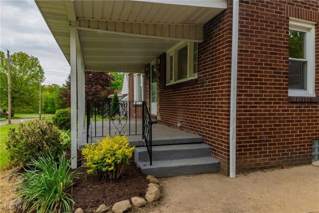 459 N Osborn Ave, Youngstown, OH 44509 - view of side of home featuring brick siding and a porch