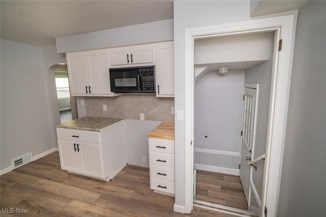 459 N Osborn Ave, Youngstown, OH 44509 - kitchen with black microwave, wood finished floors, decorative backsplash, light countertops, and arched walkways