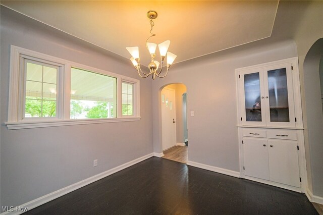459 N Osborn Ave, Youngstown, OH 44509 - unfurnished dining area with arched walkways, dark wood-style floors, plenty of natural light, and a chandelier