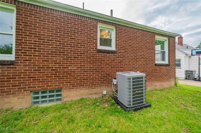 459 N Osborn Ave, Youngstown, OH 44509 - view of property exterior featuring central air condition unit, a yard, and brick siding