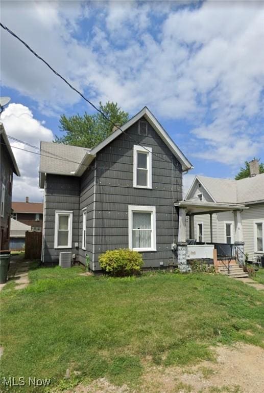 1315 18th St SW, Canton, OH 44706 - rear view of house with a lawn, a porch, and central AC