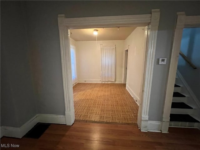 1315 18th St SW, Canton, OH 44706 - hallway with baseboards, stairway, and parquet flooring