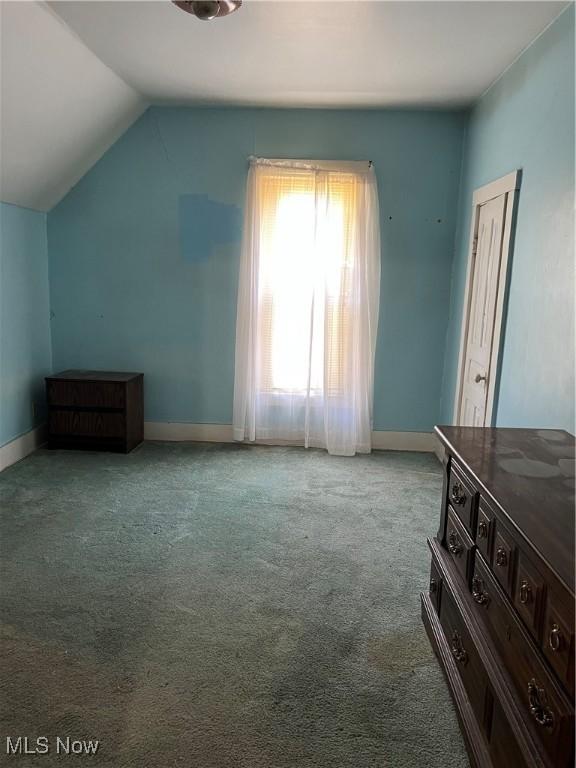 1315 18th St SW, Canton, OH 44706 - unfurnished bedroom with vaulted ceiling, carpet floors, and baseboards