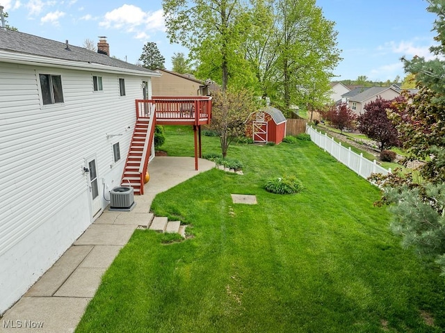 view of yard featuring stairs, cooling unit, a deck, a patio, and a shed