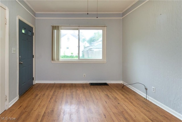114 Mendel Ct, Elyria, OH 44035 - spare room with ornamental molding, wood finished floors, and baseboards