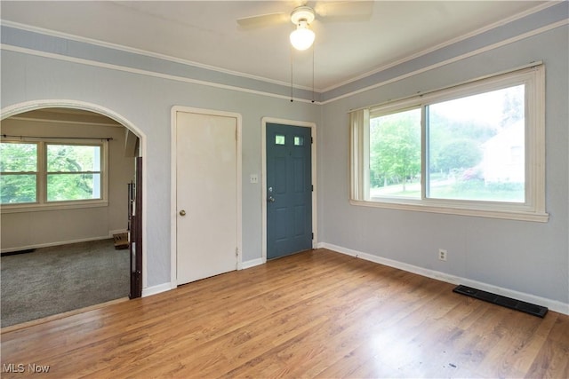 114 Mendel Ct, Elyria, OH 44035 - unfurnished room featuring arched walkways, crown molding, light wood-style flooring, a ceiling fan, and baseboards