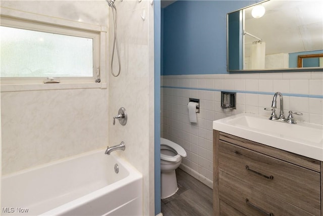 114 Mendel Ct, Elyria, OH 44035 - full bath with toilet, shower / bath combo with shower curtain, vanity, tile walls, and wood finished floors