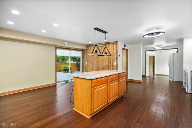 1287 E Garnet Ave, Port Clinton, OH 43452 - kitchen with freestanding refrigerator, recessed lighting, dark wood-style flooring, light stone countertops, and baseboards
