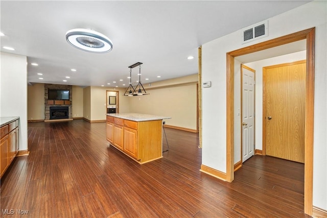 1287 E Garnet Ave, Port Clinton, OH 43452 - kitchen with dark wood-style flooring, recessed lighting, light countertops, baseboards, and a stone fireplace