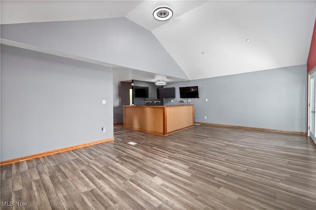 1287 E Garnet Ave, Port Clinton, OH 43452 - unfurnished living room with baseboards, high vaulted ceiling, and wood finished floors